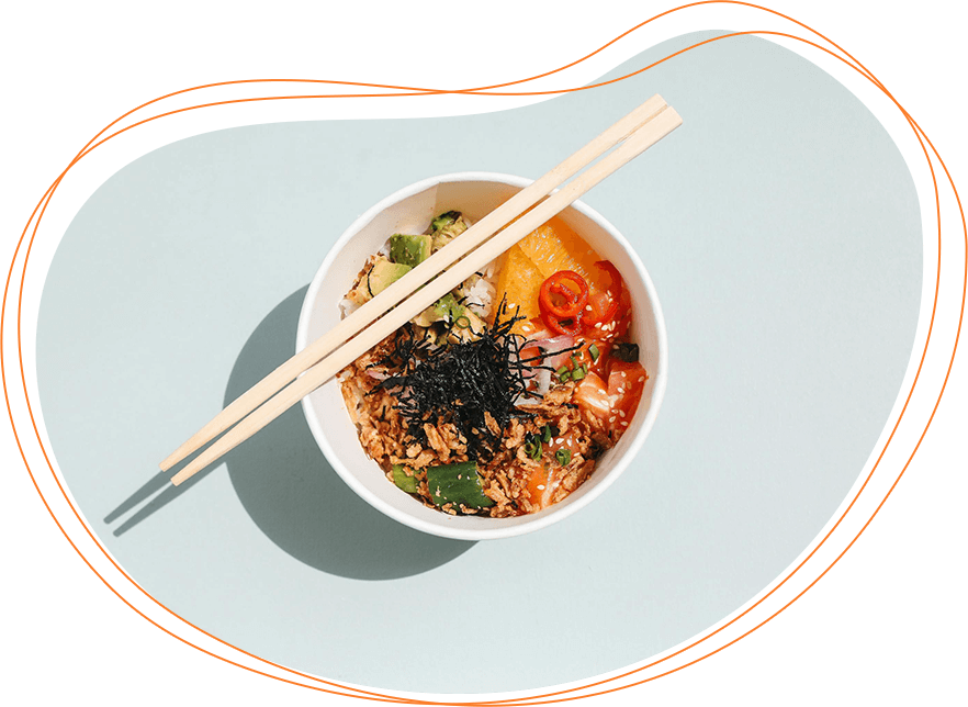 A bowl of asian-style fried rice with vegetables, topped with seaweed, served with chopsticks on a light blue surface.